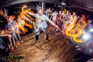 Drummer from Enter Shikari moshing in a nightclub with a crowd around him