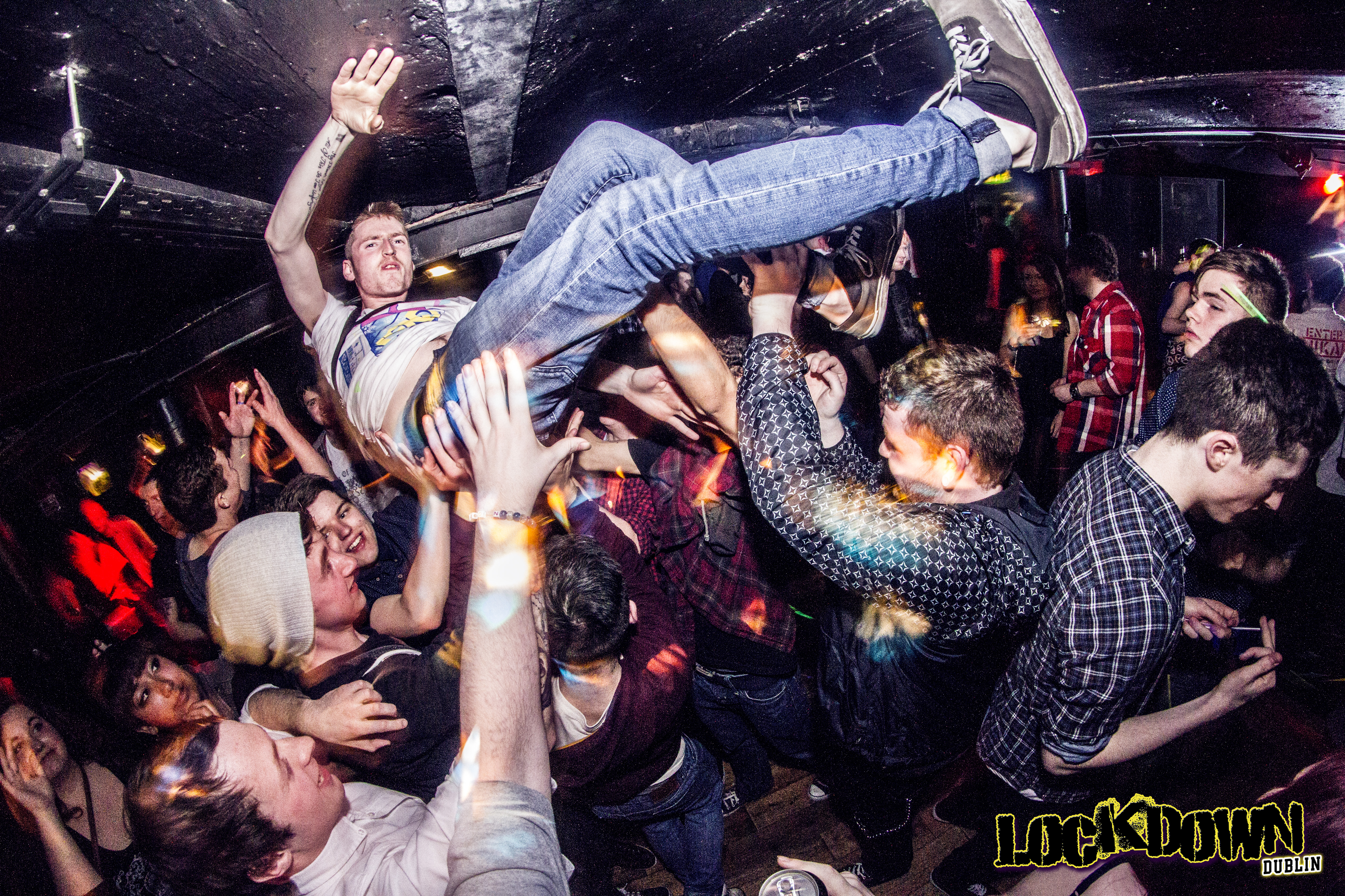 Man crowdsurfing at nightclub